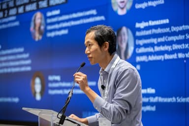 Percy Liang standing at the podium